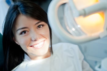 Young woman smiling in the dentist chair